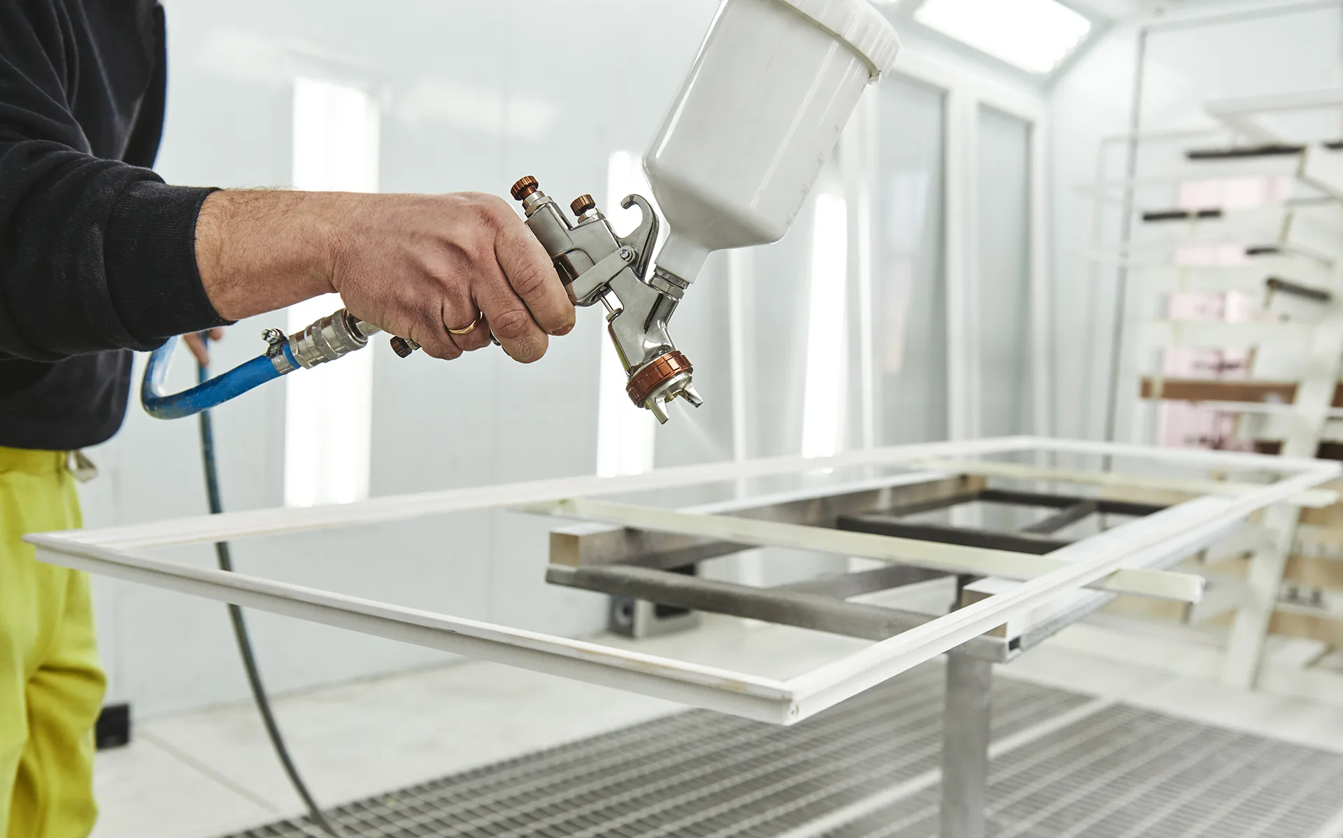 Professional spray painting of a metal frame