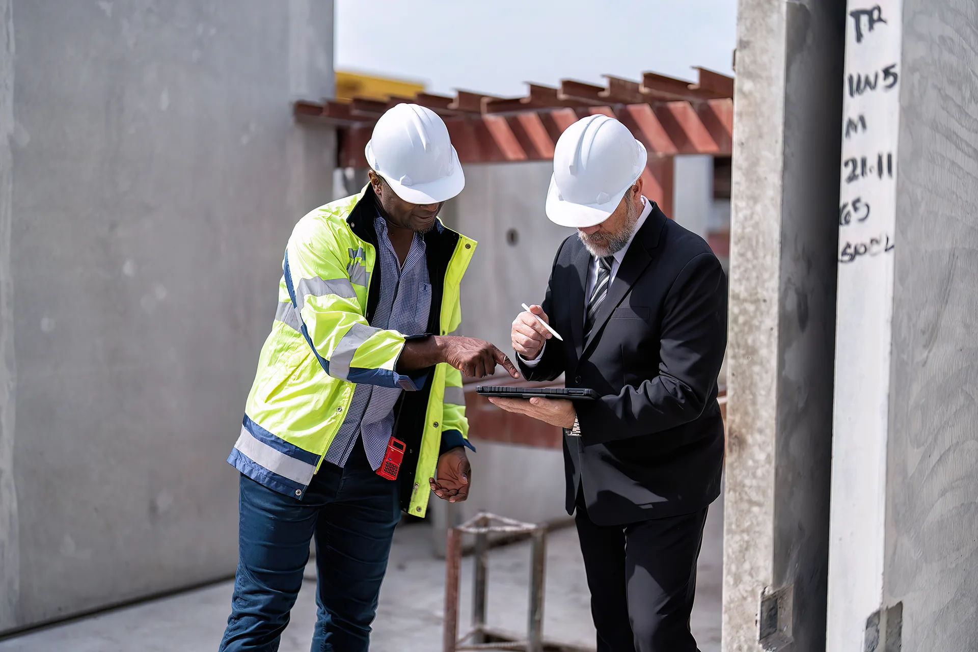 Construction specialists reviewing a concrete project assessment